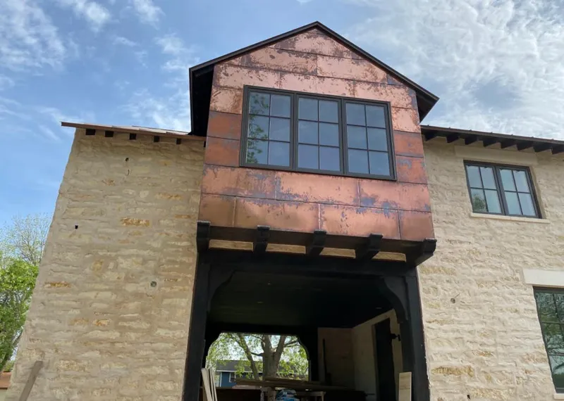 Copper metal panel facade on a stone building for Skylight Installation in Orlando
