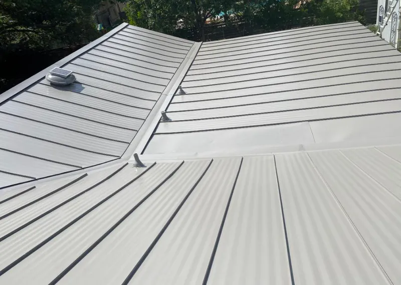 Solar attic fan installed on a metal roof for Roof Ventilation in Orlando