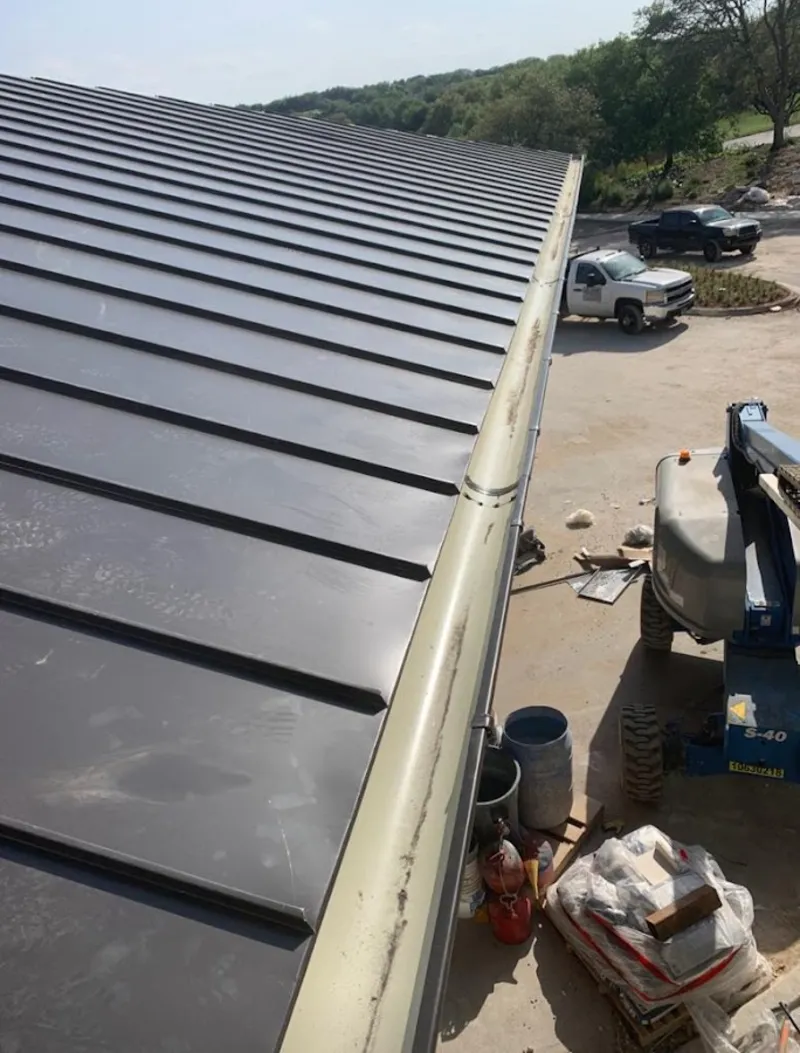 Standing seam panel and gutter detail on a metal roofing jobsite in Orlando